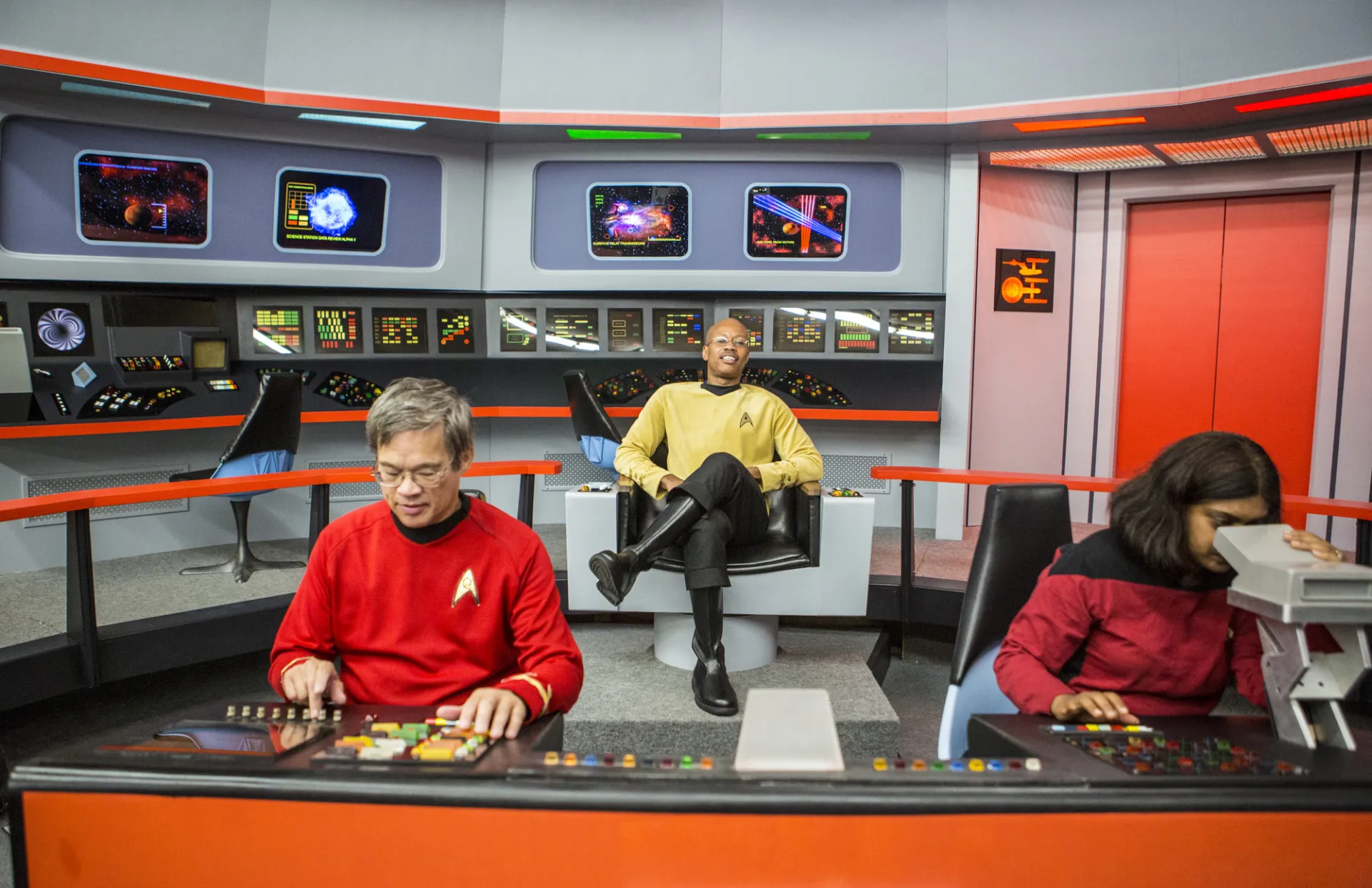 People dress up as star trek characters and sit on set. 